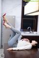 A woman laying on a table with her legs up in the air.